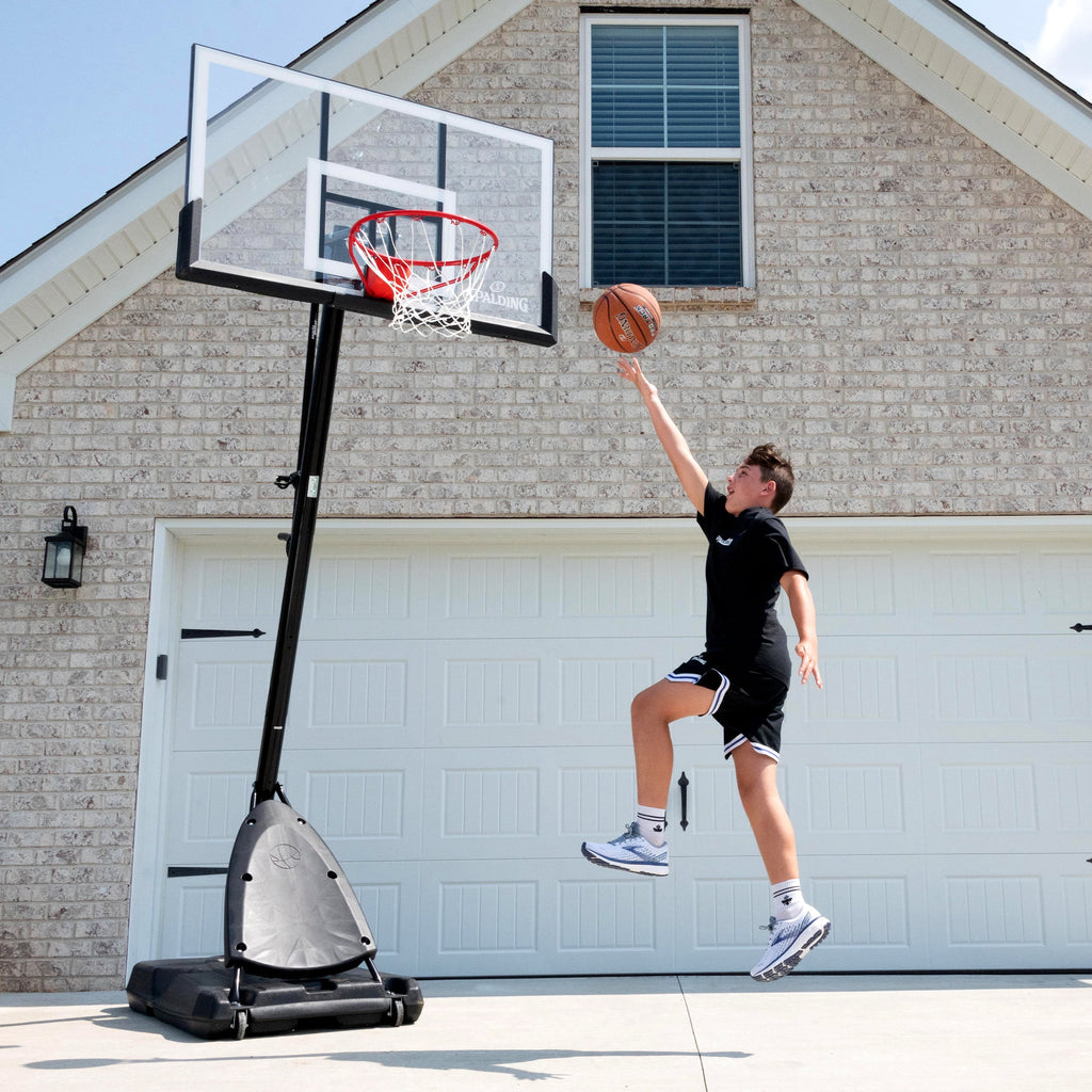 2025 Canasta de Baloncesto Portátil Spalding de 54 pulgadas – Panel de Policarbonato Irrompible, Sistema ExactaHeight y Aro Pro Slam – Juego al Aire Libre